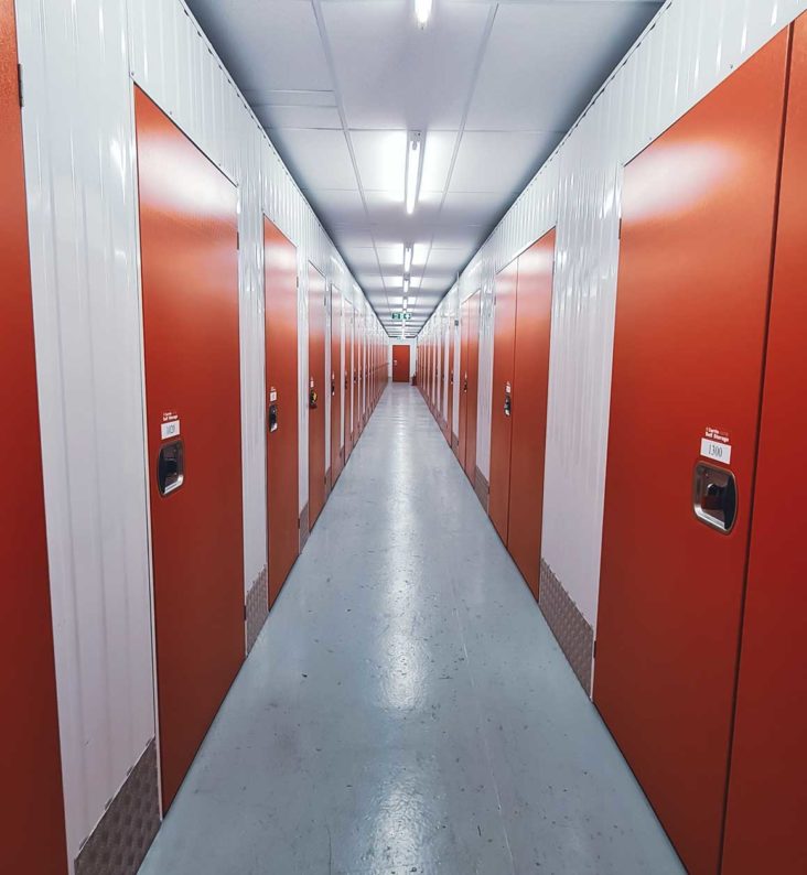 A view down the corridor of storage units at a Currie Storage facility.