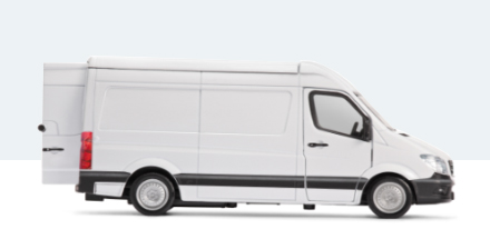 The side view of a large white van.