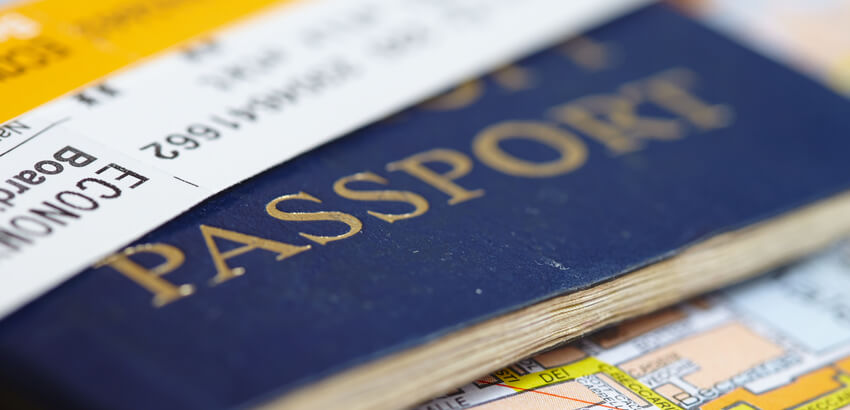Image of a blue passport and a plane ticket.