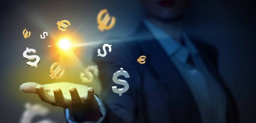 Image of man holding out his hand an illuminated currency symbols.