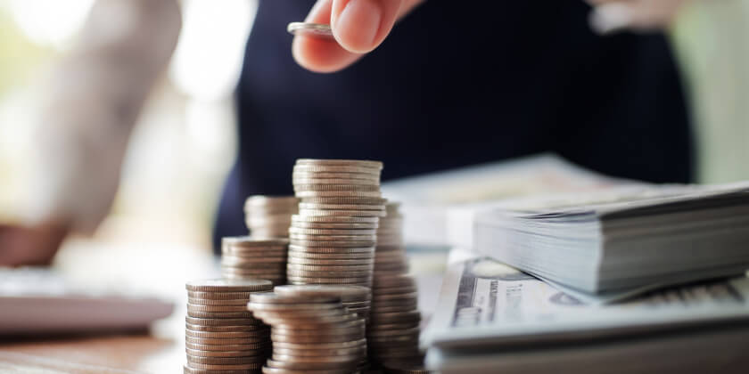 A businessperson counting the money they have saved.