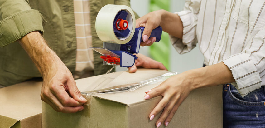 Image of a couple packing a storage box.