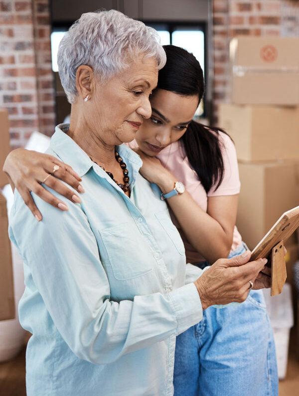 grandmother-and-graddaughter-looking-at-tablet-about-self-storage